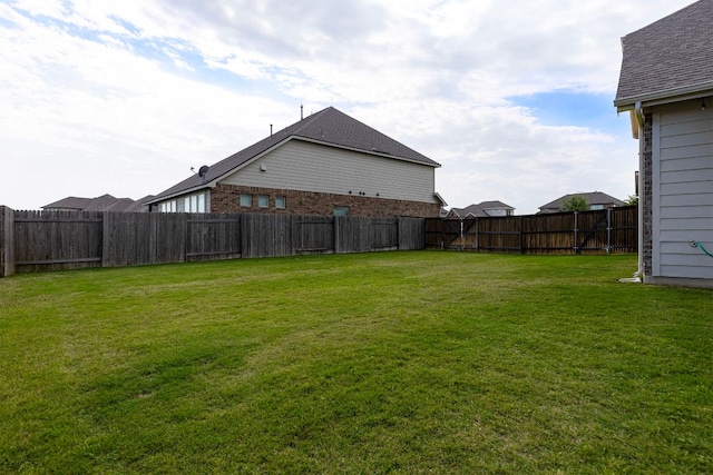 view of yard with a fenced backyard