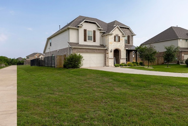 view of front of home featuring fence, an attached garage, driveway, and a front yard