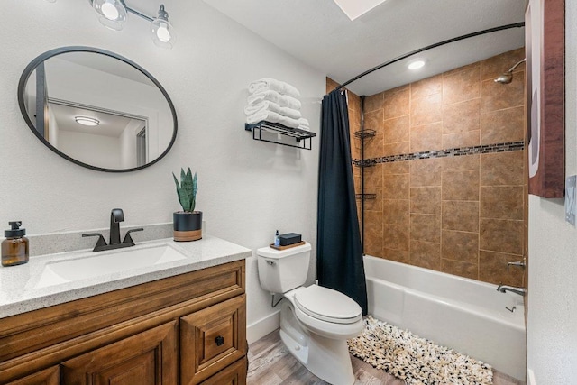 full bath featuring vanity, shower / tub combo with curtain, wood finished floors, toilet, and baseboards