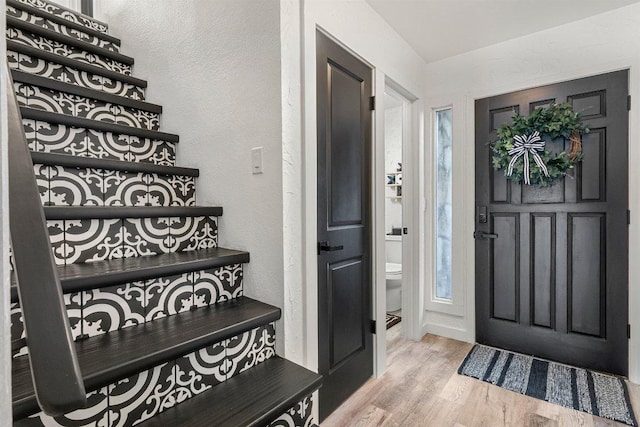 entryway with a textured wall and wood finished floors