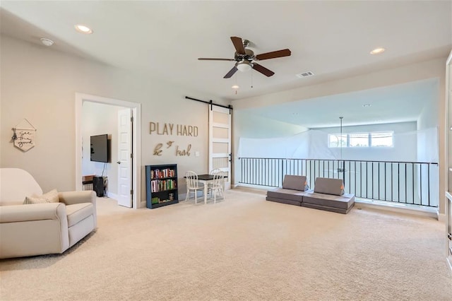 6914 Halesboro Dr, Austin, TX 78736 - carpeted living room featuring a ceiling fan, recessed lighting, a barn door, and visible vents