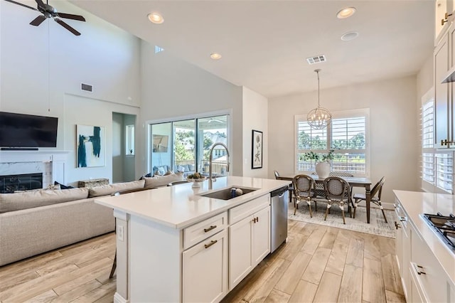 6914 Halesboro Dr, Austin, TX 78736 - kitchen featuring a healthy amount of sunlight, visible vents, appliances with stainless steel finishes, light wood-type flooring, and a sink