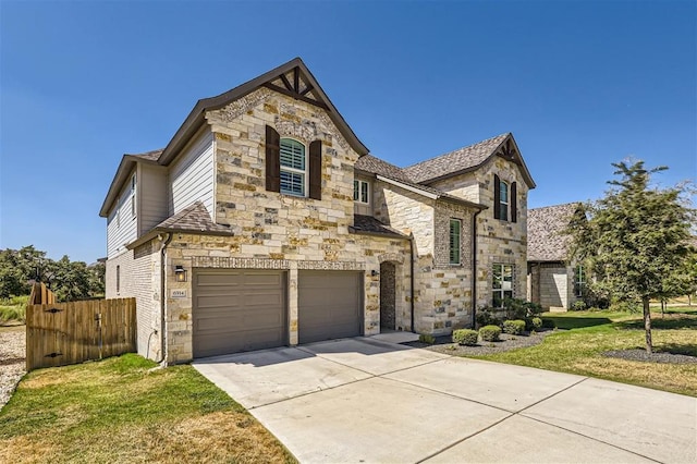 6914 Halesboro Dr, Austin, TX 78736 - view of front of property featuring a garage, fence, a front yard, stone siding, and concrete driveway