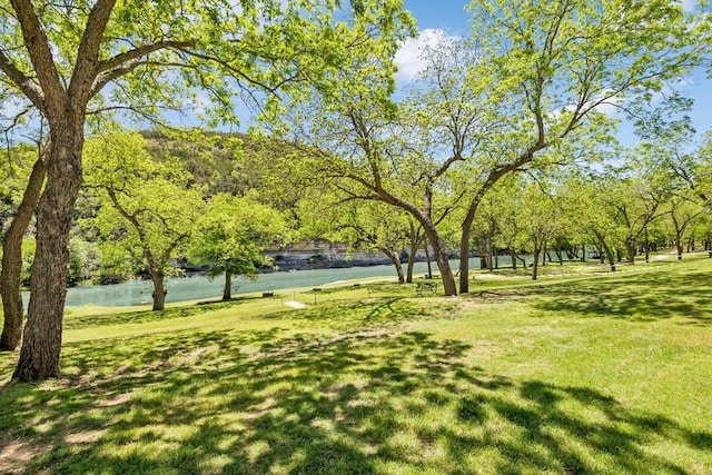 view of home's community with a yard and a water view