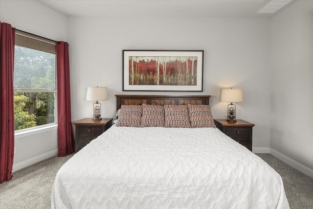 bedroom with carpet flooring, baseboards, and multiple windows