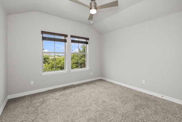 carpeted spare room with baseboards, a ceiling fan, and lofted ceiling