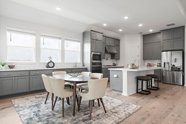 dining area featuring recessed lighting, visible vents, and light wood-type flooring