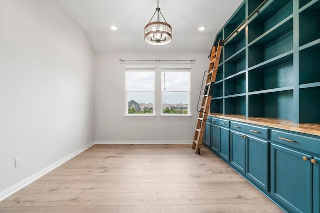 unfurnished office with light wood-type flooring, recessed lighting, baseboards, and a notable chandelier