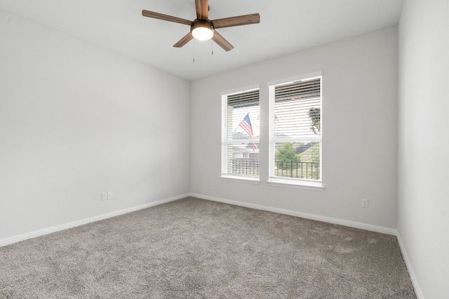 unfurnished room with baseboards, a ceiling fan, and carpet flooring