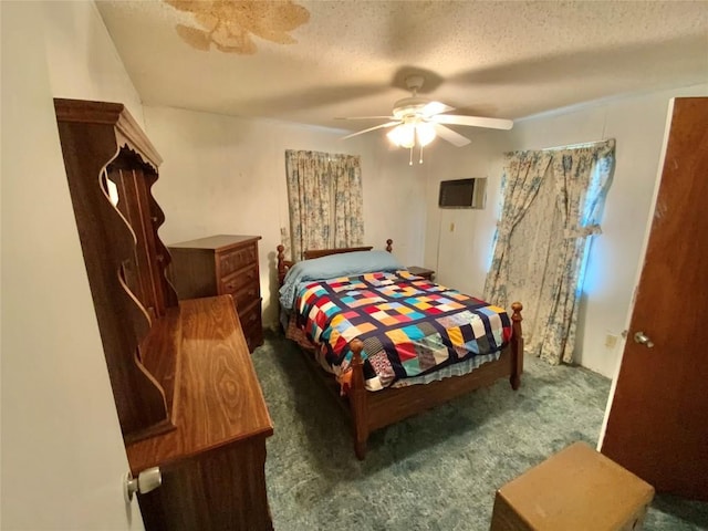 carpeted bedroom with a ceiling fan and a textured ceiling