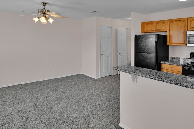 kitchen with visible vents, baseboards, ceiling fan, dark stone countertops, and black appliances