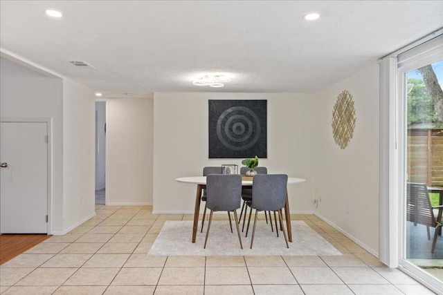 dining space featuring light tile patterned floors, baseboards, recessed lighting, and visible vents
