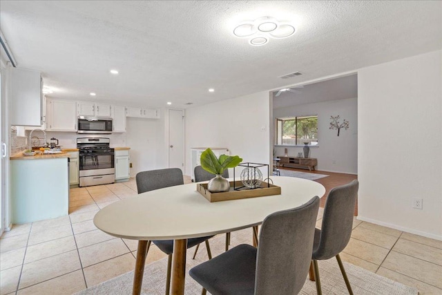 dining area featuring visible vents, baseboards, recessed lighting, a textured ceiling, and light tile patterned floors