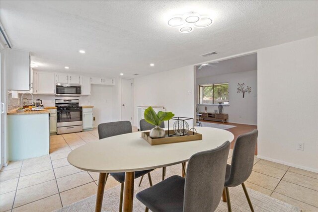 7918 Copano Dr, Austin, TX 78749 - dining room featuring light tile patterned floors, a textured ceiling, recessed lighting, and baseboards