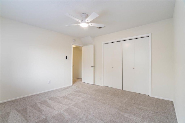 unfurnished bedroom featuring ceiling fan, visible vents, baseboards, a closet, and carpet