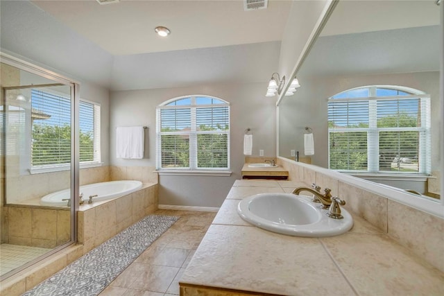 full bathroom featuring baseboards, a sink, a bath, and tile patterned floors