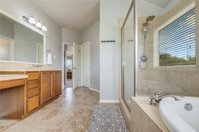 full bathroom with vanity, tile patterned flooring, baseboards, a bath, and a shower stall