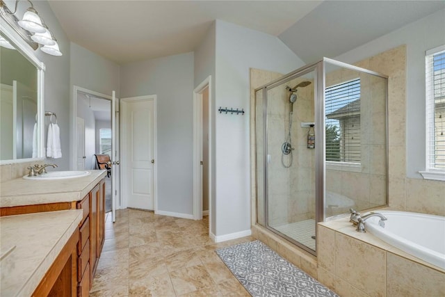 bathroom featuring a shower stall, a garden tub, and vanity