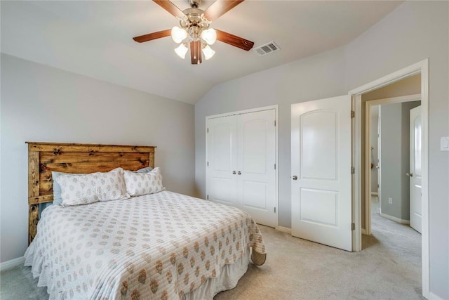 bedroom featuring light carpet, baseboards, vaulted ceiling, visible vents, and a closet