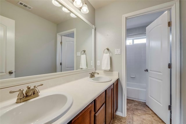 full bath featuring double vanity, visible vents, and a sink