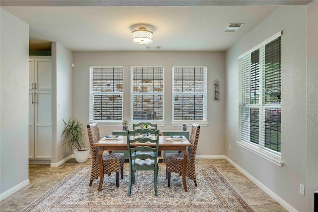 dining space with baseboards and visible vents