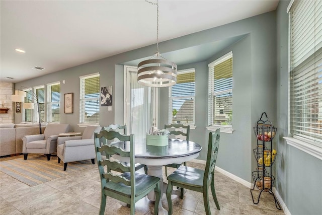 1103 Snow Goose, Leander, TX 78641 - dining room featuring an inviting chandelier, baseboards, light tile patterned flooring, and visible vents