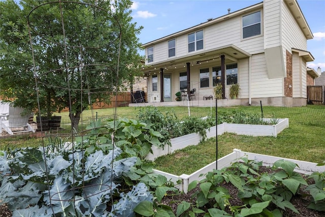 1103 Snow Goose, Leander, TX 78641 - back of house with a yard, a vegetable garden, and fence
