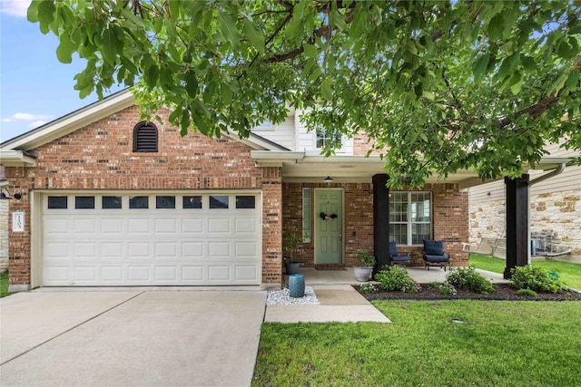 1103 Snow Goose, Leander, TX 78641 - view of front of house with covered porch, brick siding, concrete driveway, and a front yard