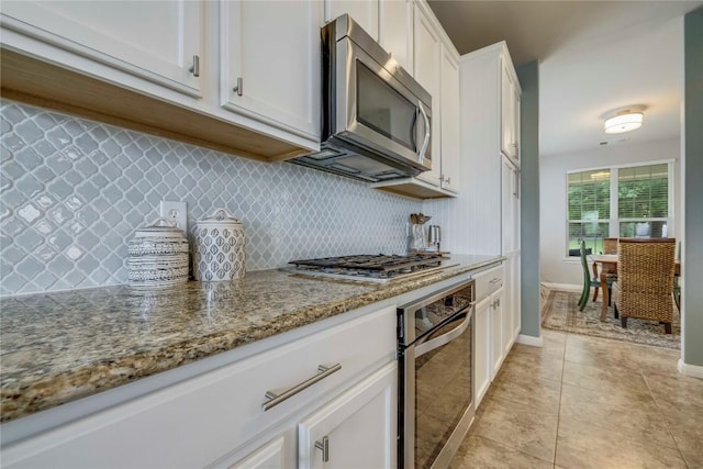1103 Snow Goose, Leander, TX 78641 - kitchen featuring backsplash, light stone countertops, white cabinetry, stainless steel appliances, and light tile patterned flooring