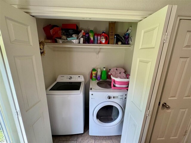10608 Plains Trl Unit B, Austin, TX 78758 - clothes washing area featuring washer and clothes dryer and tile patterned floors