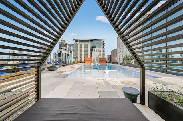 pool with a city view and a patio
