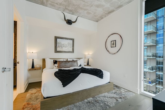 bedroom featuring baseboards and wood finished floors