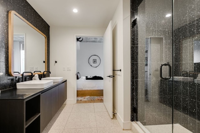 bathroom featuring ensuite bathroom, a sink, baseboards, and recessed lighting