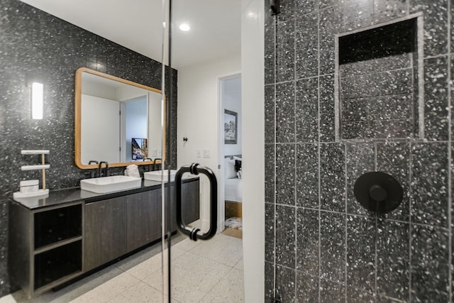 full bath featuring vanity, recessed lighting, and tiled shower