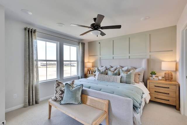 bedroom with baseboards, ceiling fan, and light carpet