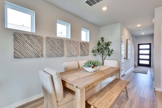 dining space with baseboards, recessed lighting, light wood-style flooring, and visible vents