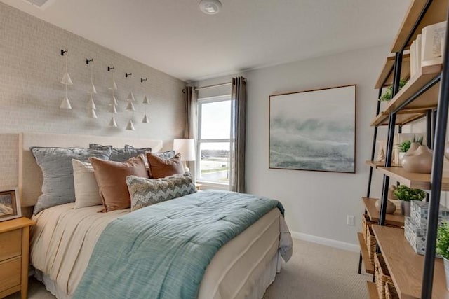 bedroom with baseboards and light colored carpet