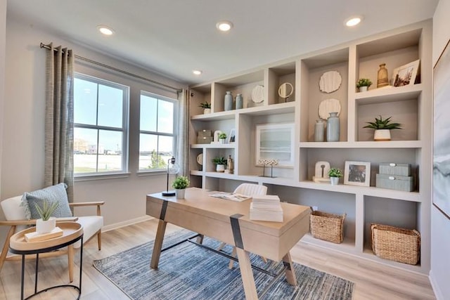 office space with baseboards, recessed lighting, light wood-style flooring, and built in features