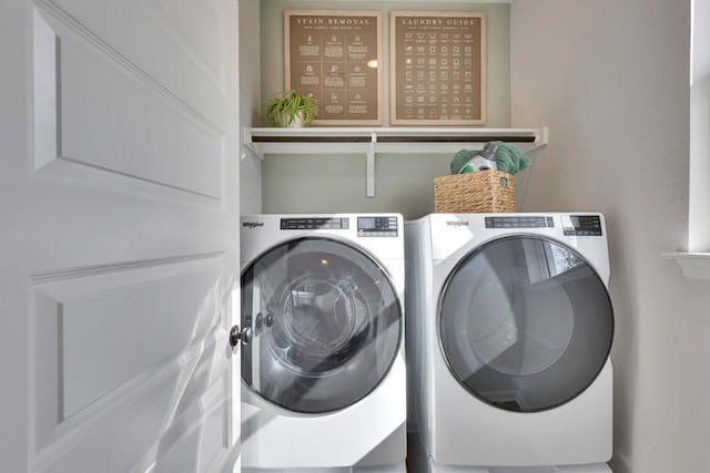 clothes washing area with separate washer and dryer and laundry area