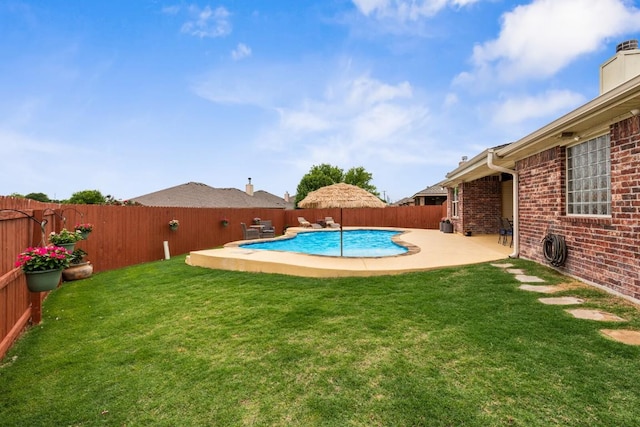 view of pool with a fenced backyard, a fenced in pool, and a lawn