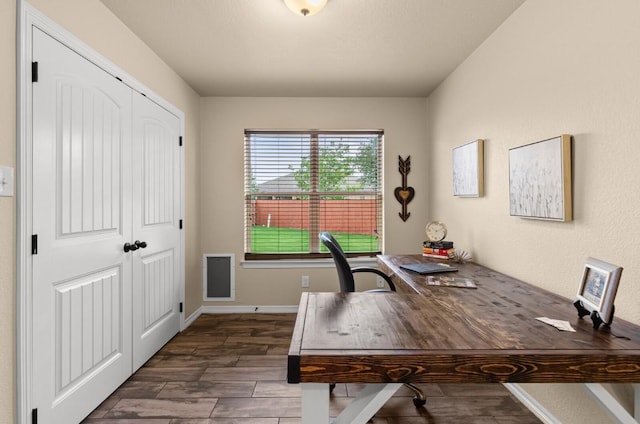 office space with baseboards and wood finished floors