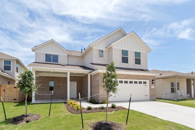 18305 Emu Ln, Manor, TX 78653 - view of front of home with board and batten siding, an attached garage, driveway, and brick siding