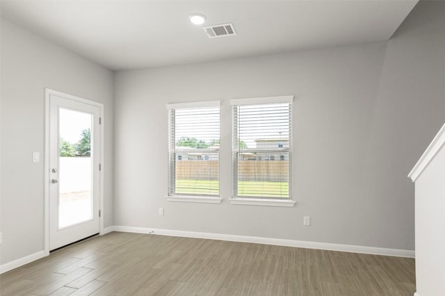 18305 Emu Ln, Manor, TX 78653 - empty room featuring healthy amount of natural light, light wood finished floors, and baseboards