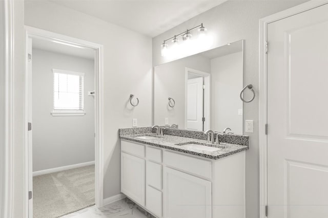 18305 Emu Ln, Manor, TX 78653 - full bathroom with double vanity, baseboards, and marble look tiles