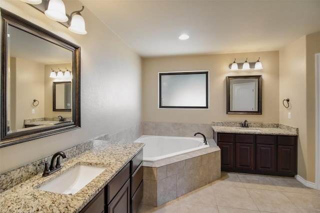 full bath featuring a sink, tile patterned flooring, a bath, and two vanities