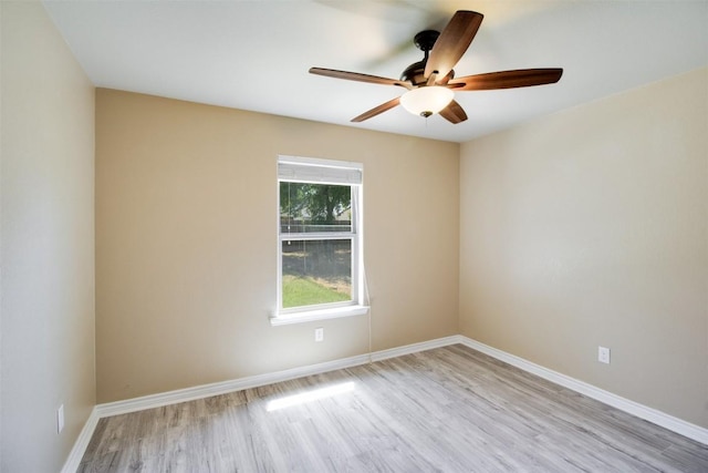 empty room featuring baseboards, ceiling fan, and wood finished floors
