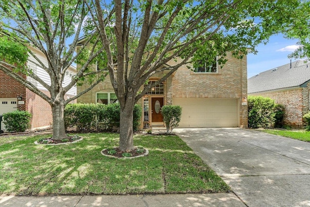 traditional-style home with brick siding, a garage, a front yard, and concrete driveway