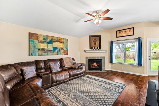 living area featuring hardwood / wood-style floors, a fireplace, baseboards, ceiling fan, and vaulted ceiling