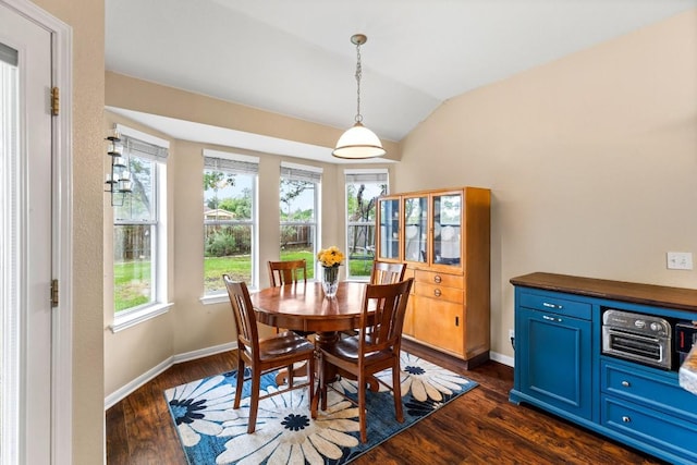dining space with baseboards, vaulted ceiling, dark wood-style floors, and a wealth of natural light
