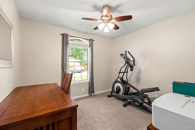 exercise room with baseboards, ceiling fan, and carpet
